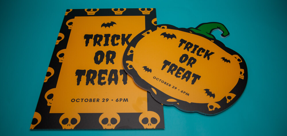 Display boards printed for Halloween, one in the shape of a pumpkin.